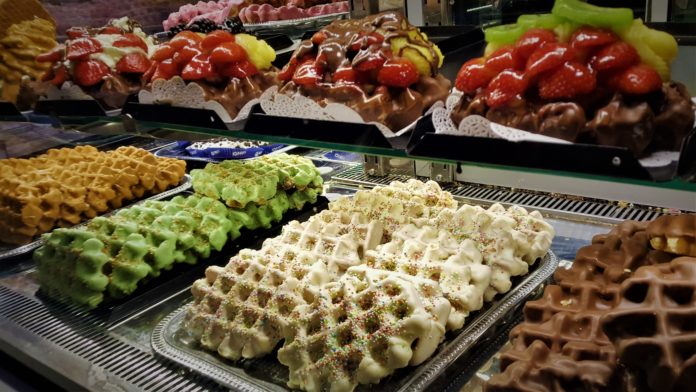 Picture of waffle pastry treats inside a bakery. If you only have 24 hours in Amsterdam, try the baked treats!