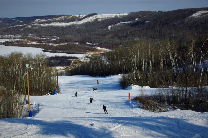 A downhill ski run is featured on the edge of a valley, in western Manitoba.