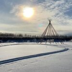 Winter solstice best time of year to reset and initiate change Sun shines bright and low in the sky over a winter wilderness landscape.