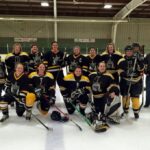 Goaldiggers: Ten years of women’s hockey The Goaldiggers women's hockey team pose together on the ice in their hockey gear and team jerseys.