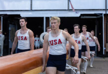 The Boys in the Boat: Underdog story of global significance Actor Callum Turner is part of the rowing crew carrying a boat, in the true story of The Boys in the Boat, released by MGM Studios.