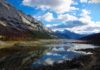 Real life places in the songs of John Denver The picture shows a beautiful blue lake reflecting a mountain, in Jasper, Alberta. Scenes like this come to life in the songs of John Denver.