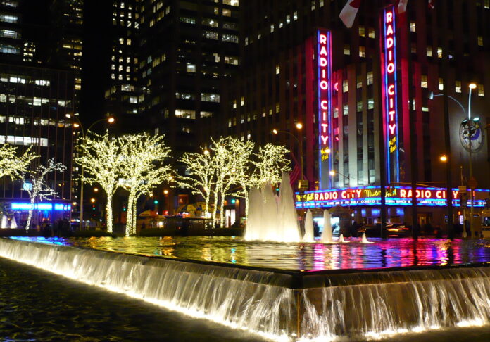 The vertical marquee lights of Radio City in downtown New York at Christmas time add to the warmth of the season and the city's tradition.