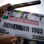 November 1963 movie: The killing of a president A film clapper-board is open and raised to the sky, with the words November 1963 written on them, along with the director's name, Roland Joffe at the bottom.