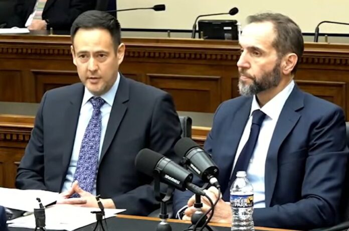 Jack Smith sits beside his lawyer to provide deposition.